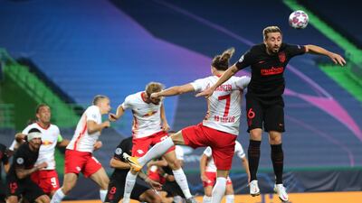Atletico Madrid's Mexican midfielder Hector Herrera jumps with Leipzig's Austrian midfielder Marcel Sabitzer. AFP