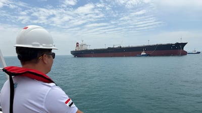 A sailor observes the oil tanker Helga, which is moored at an oil terminal near Basra in Iraq. Reuters