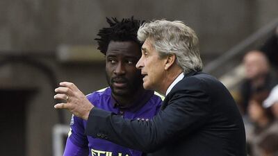 Manchester City manager gives Wilfried Bony instructions ahead of the striker's goal-scoring cameo at Swansea City. Rebecca Naden / Reuters