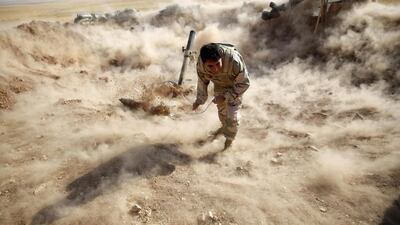 A Kurdish Peshmerga fighter launches mortar shells towards ISIL positions on September 15, 2014. Ahmed Jadallah/Reuters