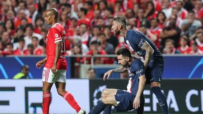 Paris Saint Germain's Sergio Ramos helps up team-mate Lionel Messi. EPA