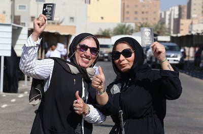 Kuwaiti women display their passports as they vote during parliamentary elections in Kuwait City on September 29, 2022. AFP