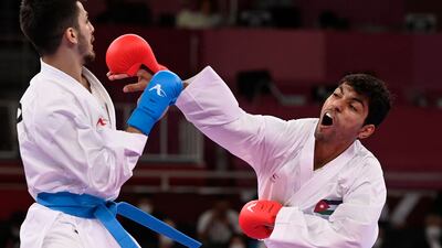 Turkish karate star Eray Samdan (L), who won silver, competes against Jordan's Abdel Rahman Almasatfa, who won bronze in the men's kumite 67kg in Tokyo.