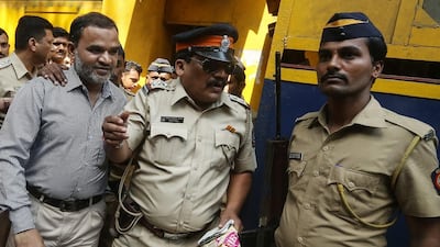 Police officers escort a man accused of being involved in the 2006 Mumbai bombings of commuter trains at Arthur Road Jail in Mumbai. Divyakant Solanki / EPA