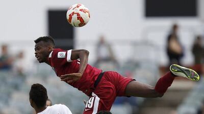 Qatar's Mohammed Muntari jumps for the ball over UAE players during their Asian Cup Group C match on Sunday in Canberra, Australia. Tim Wimborne / Reuters