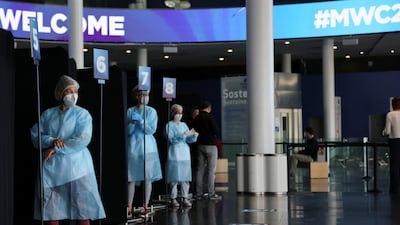 Workers wait to collect a coronavirus disease swab sample in the Fira of Barcelona, Spain. Reuters