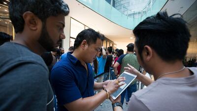 Apple customers in Dubai Mall register for the product they want. Leslie Pableo / The National