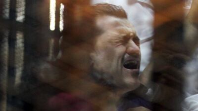 A defendant reacts behind bars in an Egyptian court on Sunday April 19, 2015 when the court imposed the death penalty on 11 men for involvement in deadly soccer stadium violence in 2012. Al Youm Al Saabi Newspaper/Reuters