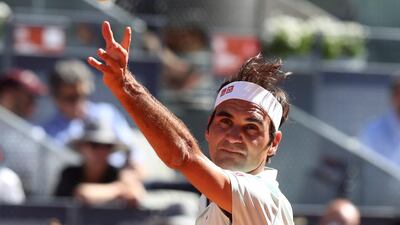 Federer keeps his eye on the ball as he serves. EPA