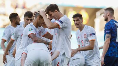 Spain players celebrate after Slovakia's Juraj Kucka scored an own. AP