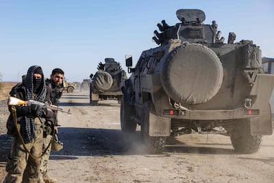 Soldiers stand guard as Syrian government forces make their way to the city of Hasakeh. AFP
