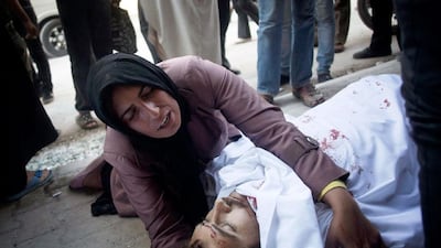 Yet another body lies in front of Dar Al Shifa hospital, this time the brother of a woman who cannot disguise her grief.