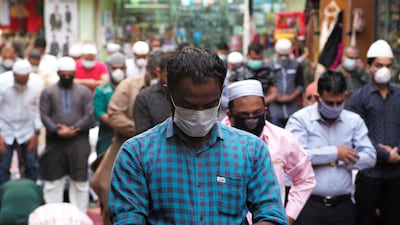 Muslims wear protective face masks following the coronavirus outbreak, as they pray on a street during Friday prayers in local souq, in Manama, Bahrain, February 28, 2020. REUTERS