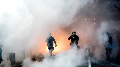 Federal officers use chemical irritants and crowd control munitions to disperse Black Lives Matter protesters in Portland. AP