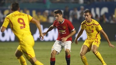 Liverpool’s Rickie Lambert, left, defends as Manchester United’s Ander Herrera moves with the ball as Liverpool’s Jordan Henderson, right, looks on during the first half of the Guinness international Champions Cup championship game at SunLife Stadium in Miami, Florida, USA on August 4, 2014. EPA/ANDREW INNERARITY