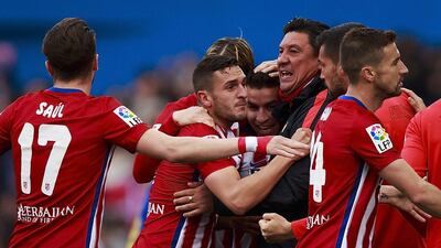 Angel Martin Correa (3dL) of Atletico de Madrid celebrates scoring their opening goal with assistant coach German Burgos (3dR) and teammates during the La Liga match between Club Atletico de Madrid and Malaga CF at Vicente Calderon Stadium on April 23, 2016 in Madrid, Spain. (Photo by Gonzalo Arroyo Moreno/Getty Images)