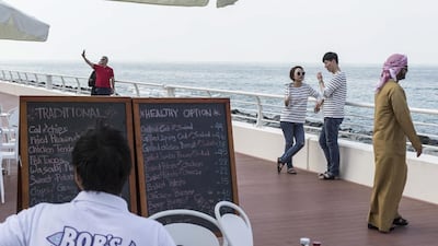 Tourists and locals take to the Boardwalk on The Palm Jumeirah, which opened on Monday in Dubai. Antonie Robertson / The National