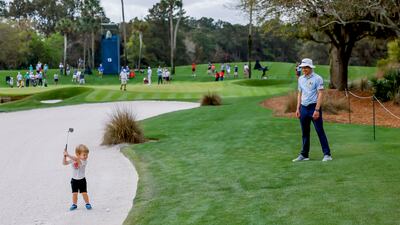 Peter Malnati, right, of the US, watches his son Hatcher hit from a bunker on the 13th hole during a practice round for The Players Championship golf tournament in Florida. The tournament runs from March 10 through March 13. EPA