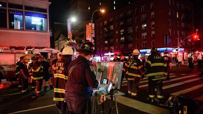New York City police and firefighters stand near the site of the explosion. Witnesses say the explosion at about 8.30pm blew out the windows of businesses and scattered debris in the area. Rashid Umar Abbasi / Reuters
