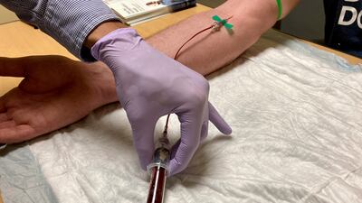 A medical worker draws blood as part of new liquid biopsy technology that could detect early signs of cancer in the blood. AP