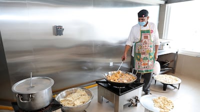 An industrial-level kitchen at the temple prepares vegetarian fare for the wedding guests
