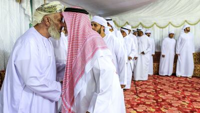 Mourners visit the Al Katheeri family at a tent to offer condolences. They enter as families. Victor Besa/The National