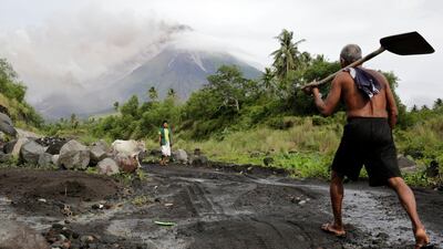 Filipino villagers walk along the slopes of rumbling Mayon Volcano as it spews ash in Legaspi city, Albay province, Philippines. Francis R. Malasig / EPA