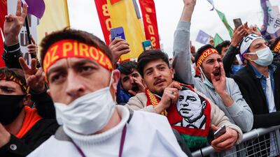 A demonstrator holds a scarf with an image of Selahattin Demirtas, a jailed former co-leader of the pro-Kurdish Peoples' Democratic Party (HDP) in Istanbul, Turkey, March 20, 2021. Reuters.