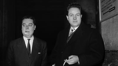 Jean-Marie Le Pen, right, MP for Paris under the banner of the National Centre for Independents and Peasants, who was accused of death threats against a police officer sent to search his home in January 1960, leaves the Palais de Justice in Paris accompanied by lawyer Pierre Menuet on January 30, 1960. AFP