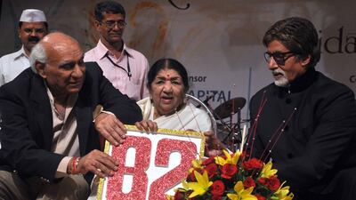Mangeshkar, centre, with Bollywood actor Amitabh Bachchan, right, and producer and director Yash Chopra during celebrations for her 82nd birthday in Mumbai on September 28, 2011. AFP