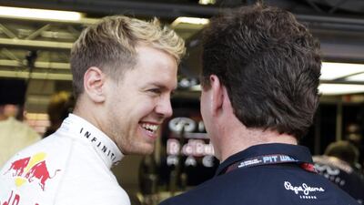 Red Bull driver Sebastian Vettel of Germany, left, talks to Red Bull team principal Christian Horner in the team's garage during qualifying for the Singapore Grand Prix on Saturday. Pablo Sanchez / Reuters