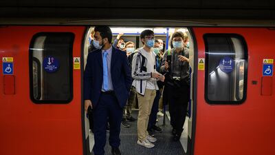 Passengers wait for the first train to leave Battersea Power Station.