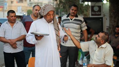 An Iraqi man performs a theatrical skit on the Corniche Street in the southern Iraqi city of Kut on July 6, 2018. AFP