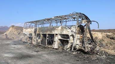The wreckage of the bus after it burst into flames in Abyan, Yemen. Reuters