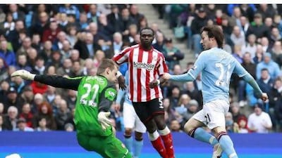 David Silva, right, scores Manchester City's third goal against Sunderland. The 5-0 victory moved them up to third in the table.