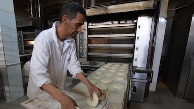A baker prepares dough at a bakery in Tunis. Russia's invasion of Ukraine could mean less bread on the table in some Middle East and African countries. Tunisia relies on Ukrainian and Russian imports for 60 per cent of its total wheat consumption. AFP