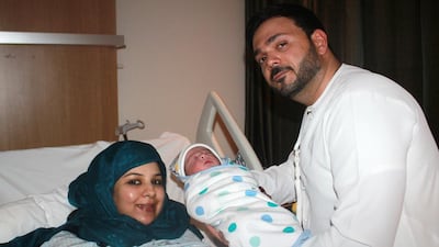 Mohammed Alhammadi and Fatima Ezzahra Salama on Monday with their newborn, leap-year baby, Khalifa, who was named after President Sheikh Khalifa. Courtesy Burjeel Hospital Abu Dhabi