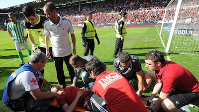 An injured Osasuna fan is attended to after Sunday's barrier collapse at El Sadar stadium. Denis Doyle / Getty Images / May 18, 2014