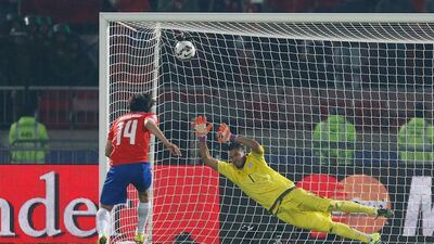 Chile's Matias Fernandez scores past Argentina goalkeeper Sergio Romero during the penalty shootout at the end of the Copa America final on Saturday. Andre Penner / AP
