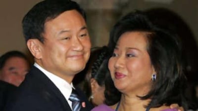 The former Thai prime minister Thaksin Shinawatra hugging his wife Pojaman. Nearly two years after he was deposed by a military coup, Mr Thaksin went on trial for corruption.