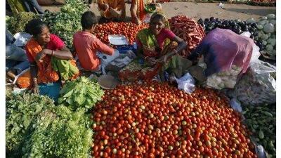 Vendors sell their vegetables at an open air fruit and vegetable market in the western Indian city of Ahmedabad.