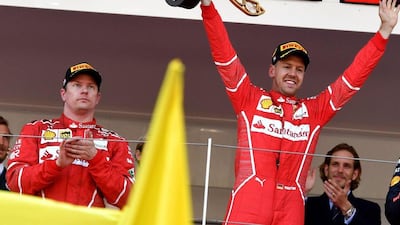 Winner Ferrari's German driver Sebastian Vettel, right, celebrates on the podium next to second placed Ferrari's Finnish driver Kimi Raikkonen after the Monaco Grand Prix on May 28, 2017 in Monaco. AFP