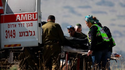Emergency workers move a victim of a shooting in the Israeli-occupied West Bank into an ambulance on Tuesday. Reuters