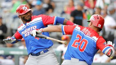 Anthony Garcia, left, of Criollos de Caguas of Puerto Rico celebrates after scoring against Caribes de Anzoategui of Venezuela during the Caribbean Baseball Series at the Charros Jalisco stadium in Guadalajara, Jalisco state. Mexico Ulises Ruiz / AFP