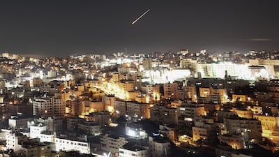 An Iranian projectile leaves a trail in the sky as seen from the Israeli-occupied West Bank city of Hebron. AFP