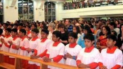 Worshippers celebrate the inaugural Mass at St Mary's Catholic Church in Al Ain, which opened on Tuesday.