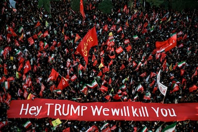 Mourners carry a banner against US President Donald Trump during the funeral of late supreme leader Ayatollah Ali Khamenei in Mashhad, Iran. Reuters