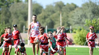 Young boys practice on the field at Dubai Police Academy, Dubai.