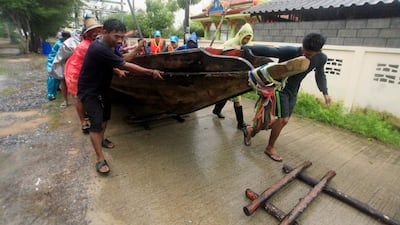 Local fishermen move a boat ashore in preparation for the approaching Tropical Storm Pabuk, Friday in Pak Phanang, in the southern province of Nakhon Si Thammarat, southern Thailand. AP Photo