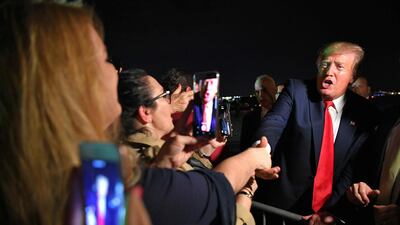 US President Donald Trump meets fans after stepping off Air Force One upon arrival at Miami International Airport in Miami, Florida. AFP